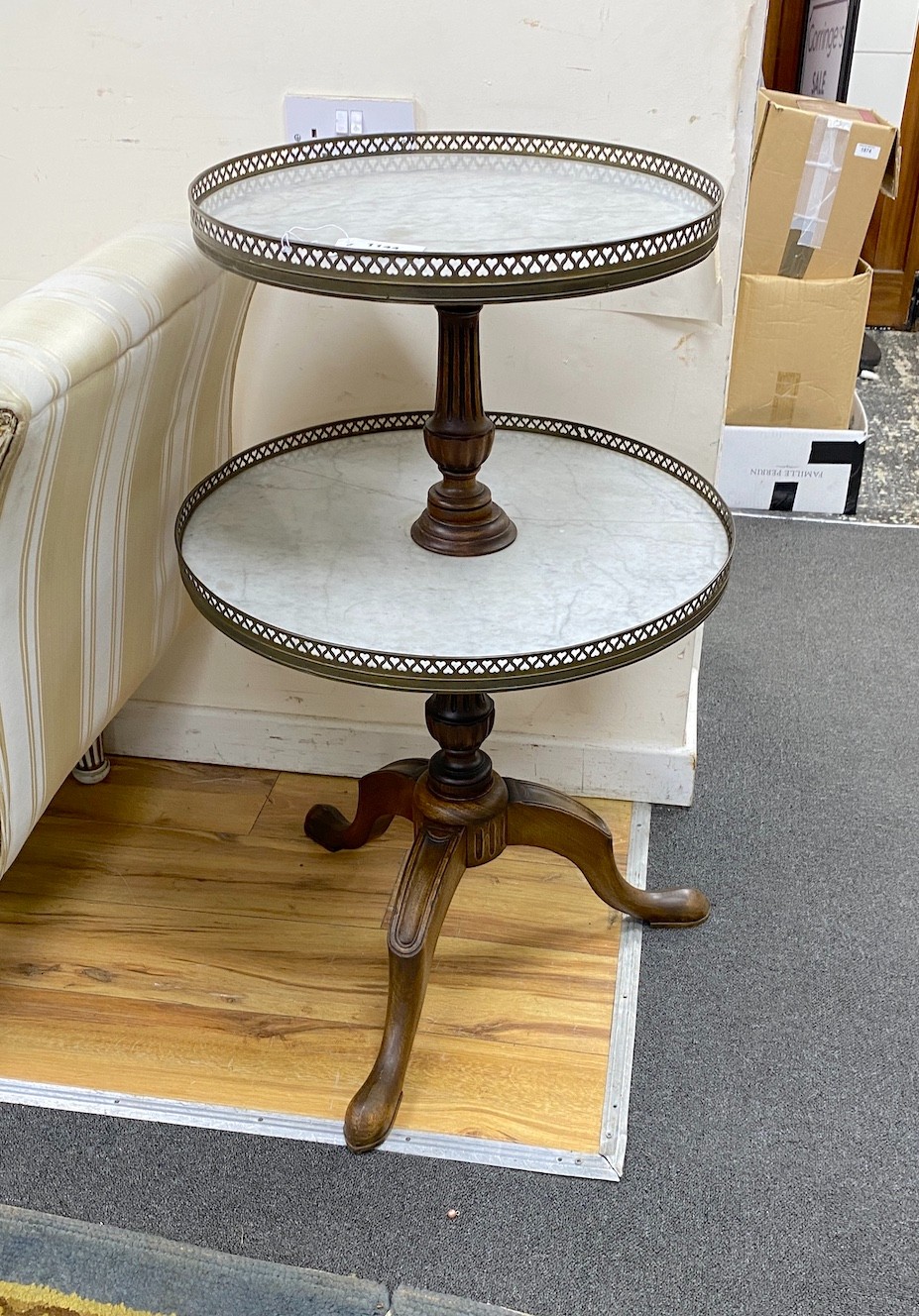 A reproduction mahogany and reconstituted marble two tier dumb waiter, height 92cm
